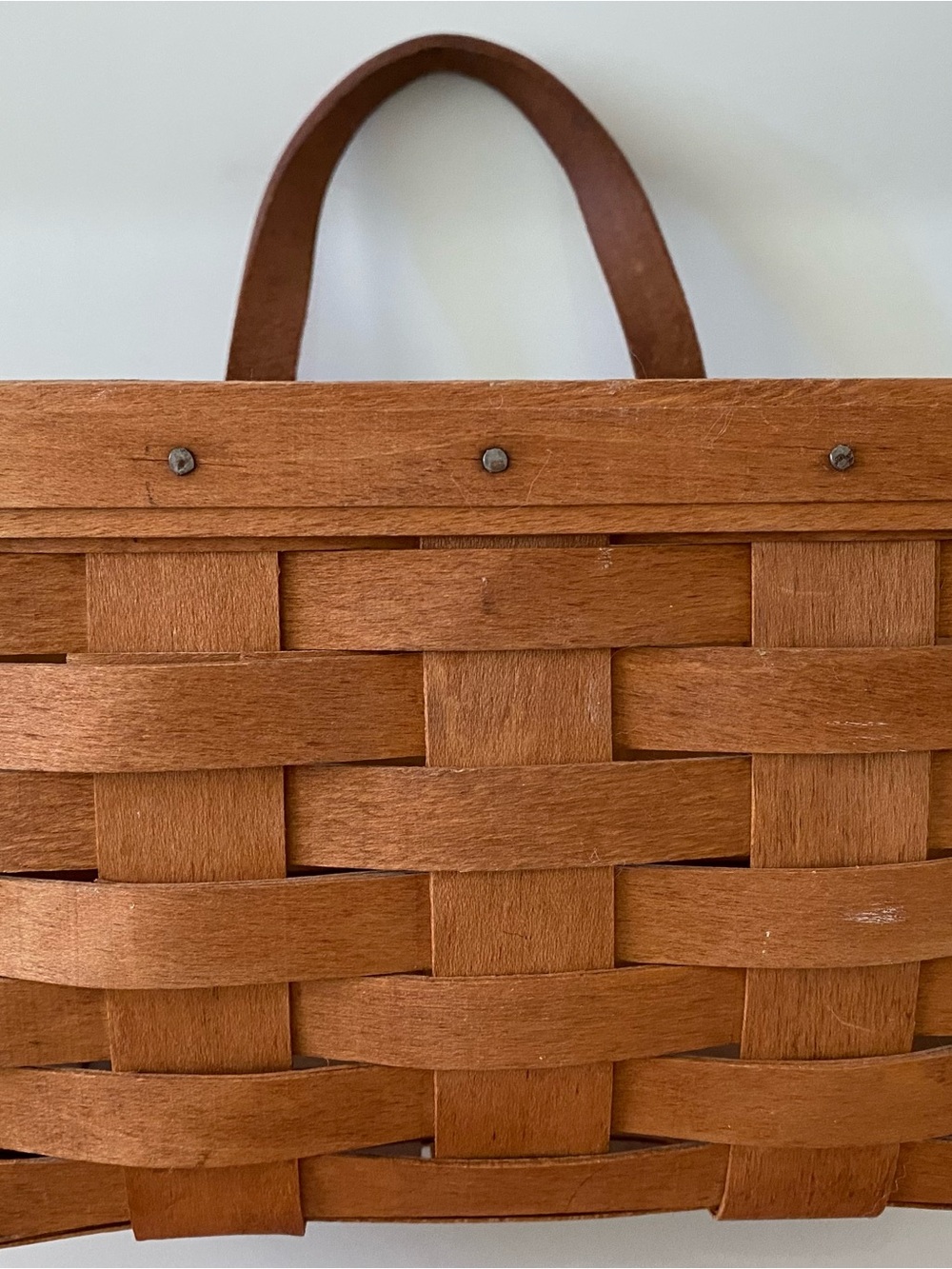 Vintage handwoven Longaberger Medium Key Basket with a leather handle.